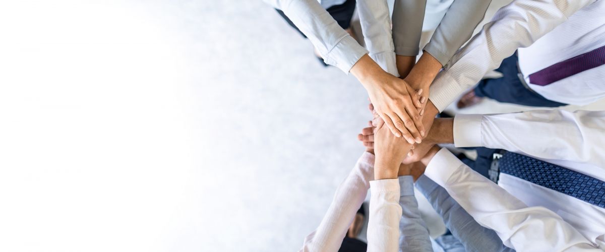 Ein Team bildet einen Kreis mit den Händen